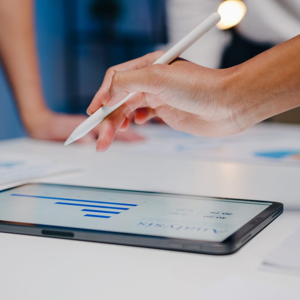 Millennial Asia businessmen and businesswomen meeting brainstorming ideas about new paperwork project colleagues working together planning success strategy enjoy teamwork in small modern night office.